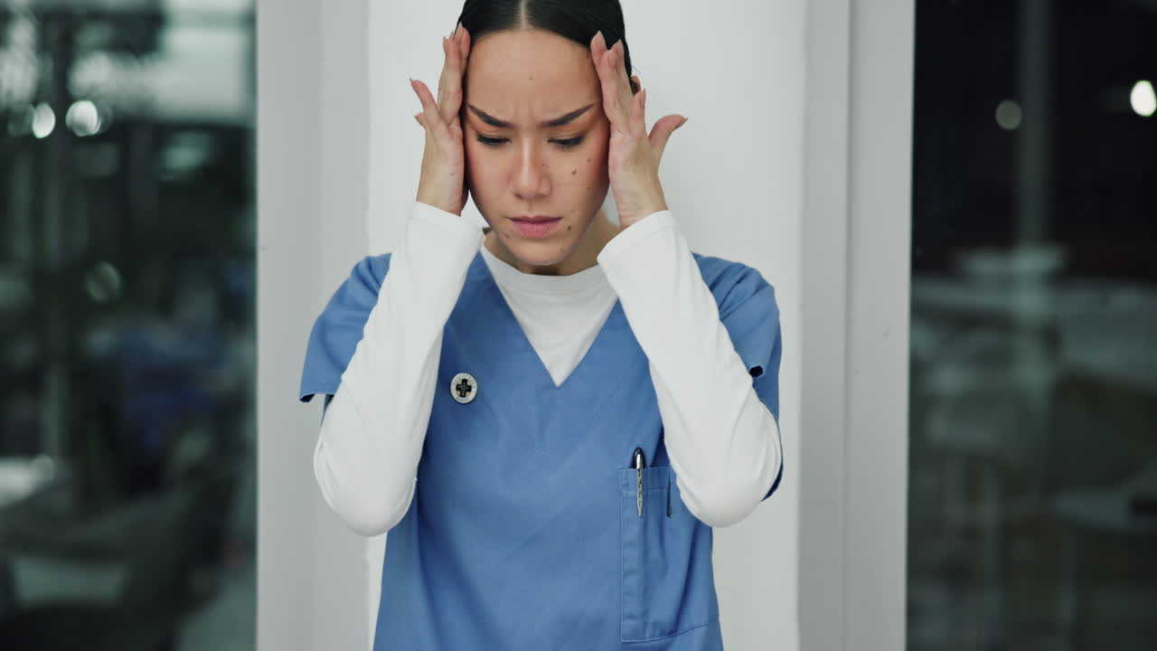 A stressed nurse with a headache