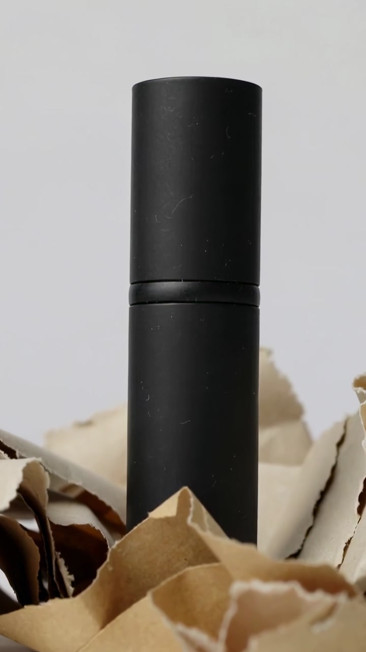 Matte Black Cylindrical Product on Crumpled Brown Paper