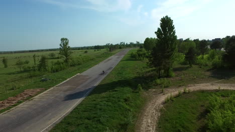 motorcyclists ride on countryside road. drone view moto race on racing track