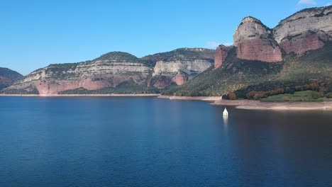 aerial views of sau reservoir in catalonia with a church in the middle