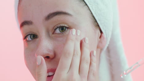 woman applying facial serum