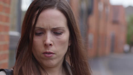 Close-Up-Of-Stressed-And-Worried-Woman-Outdoors-With-Financial-Worries-About-Cost-Of-Living-Crisis-Debt-And-Paying-Bills-Looking-At-Mobile-Phone-On-City-Street-2