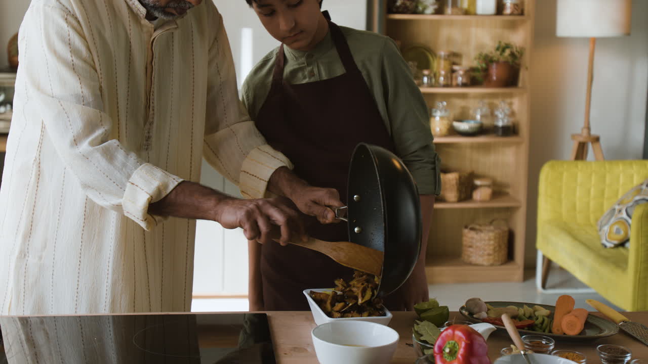 Father and Son Cooking Together in the Kitchen