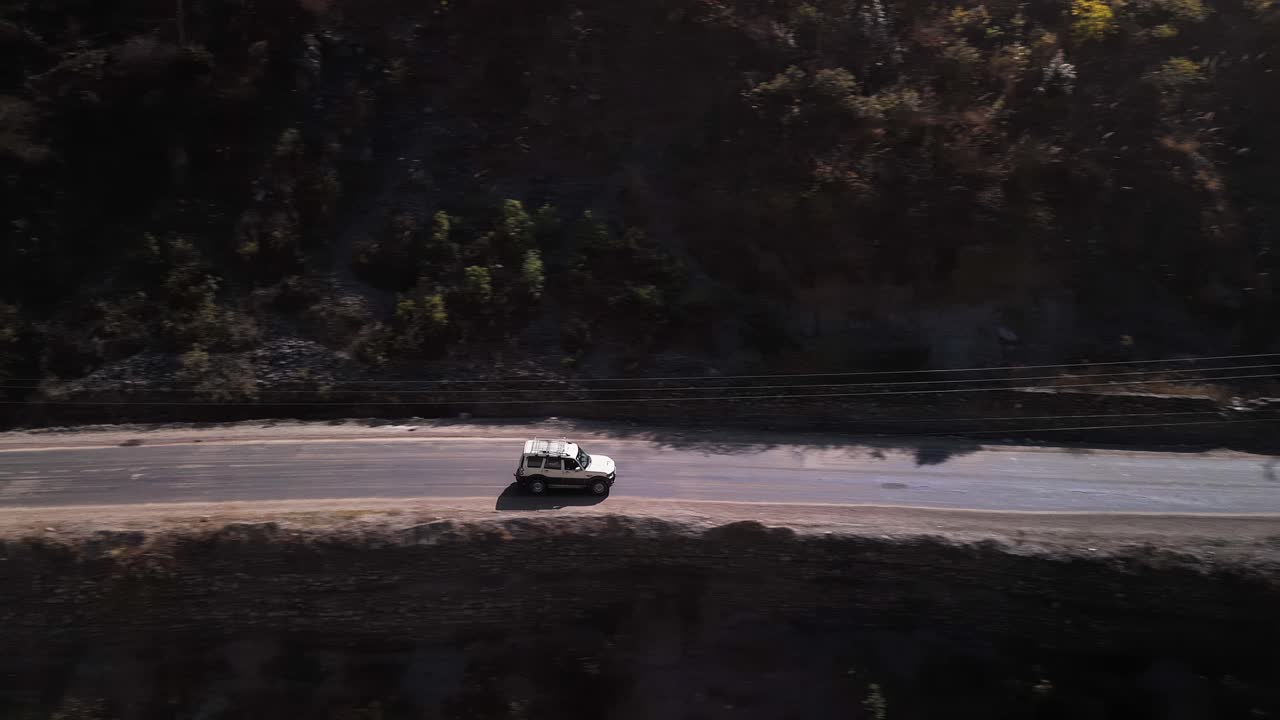 A White Car Driving Through the Scenic Mountain Landscape: Tranquil Rivers, Majestic Peaks, and Solitude, White SUV traveling