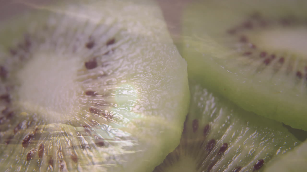 Sliced kiwi fruit showing seeds and vibrant green flesh in close-up view