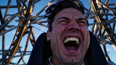 man screaming with excitement on a roller coaster