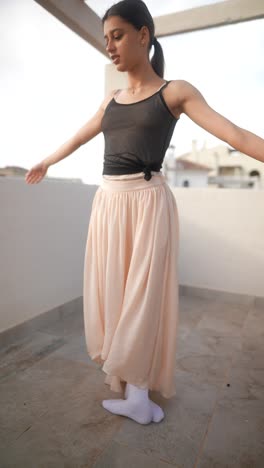 young ballerina posing on a rooftop