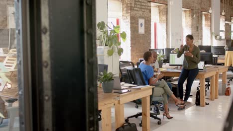 Happy-african-american-colleagues-discussing-work-and-having-lunch-in-creative-office,-slow-motion