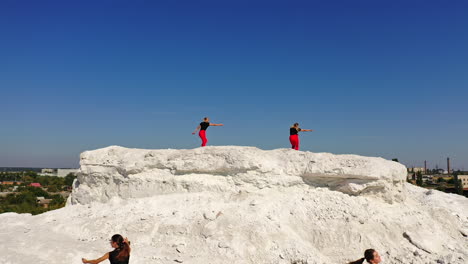 women dancing on a hill