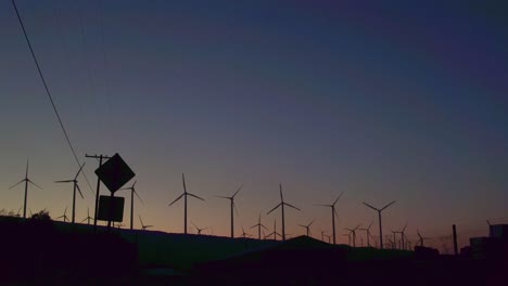 palm springs windmills with the sun coming up behind them