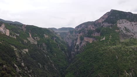 A-stunning-view-of-the-rugged-mountains-in-Albania,-showcasing-lush-greenery-and-dramatic-cliffs