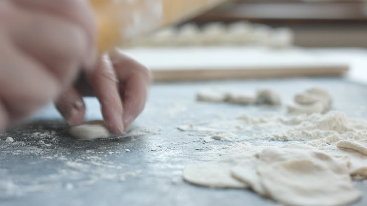 Making meat dumpling with wooden rolling pin.