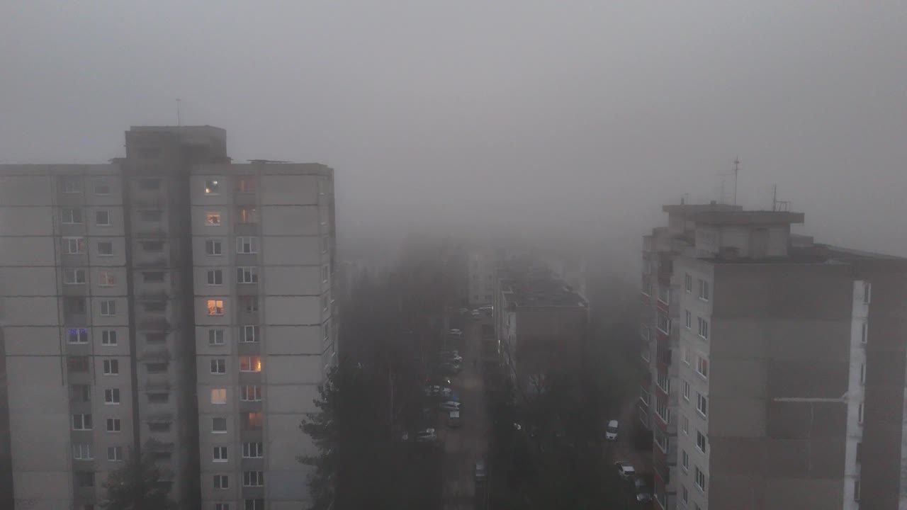 Old apartment buildings covered in extreme fog, aerial view