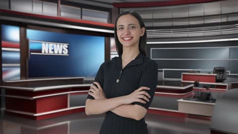 portrait of happy indian female news journalist standing crossed hands