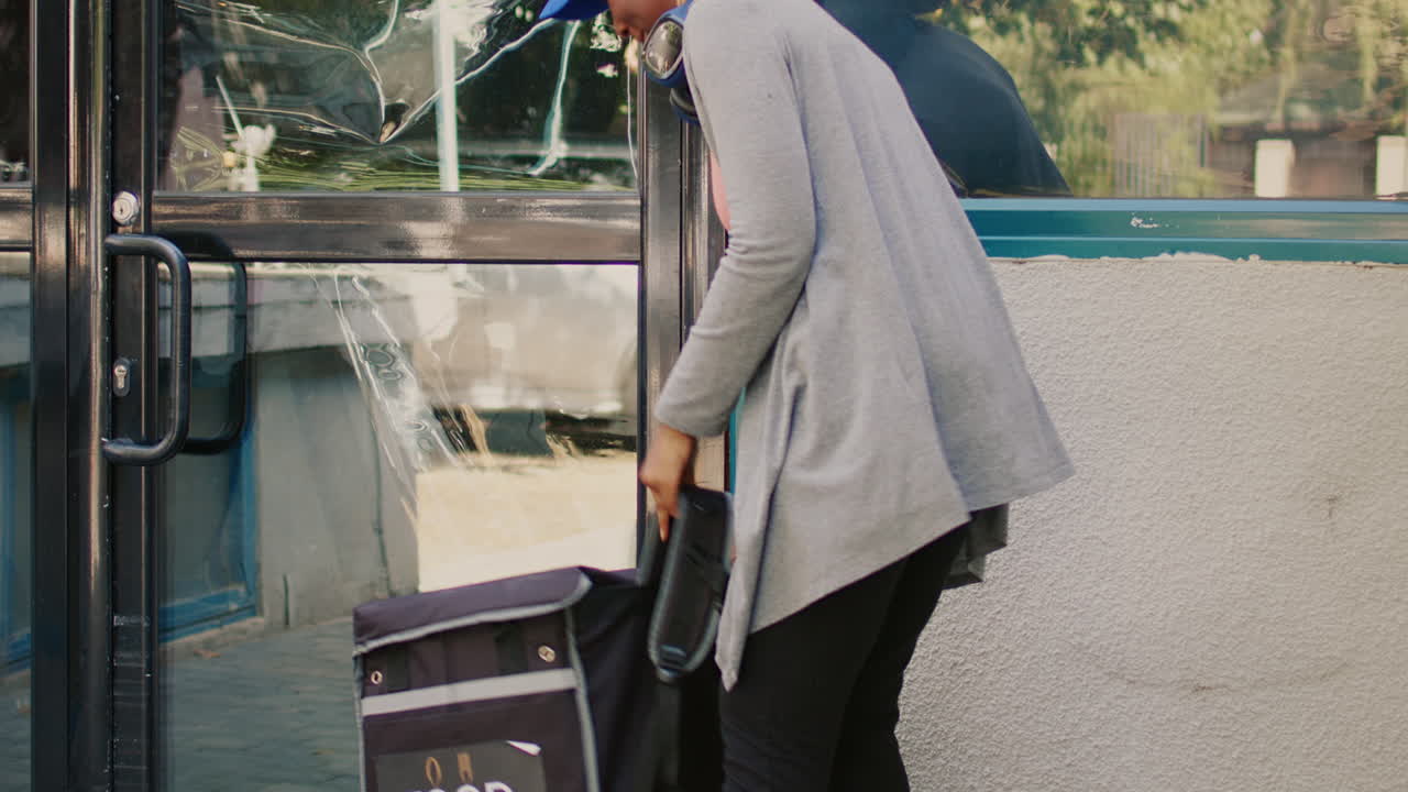 Food delivery person with backpack approaching door