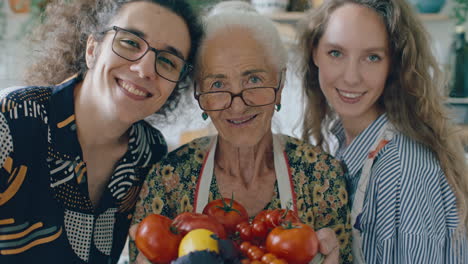 portrait of happy grandmother and grandchildren with bowl of fresh harvest