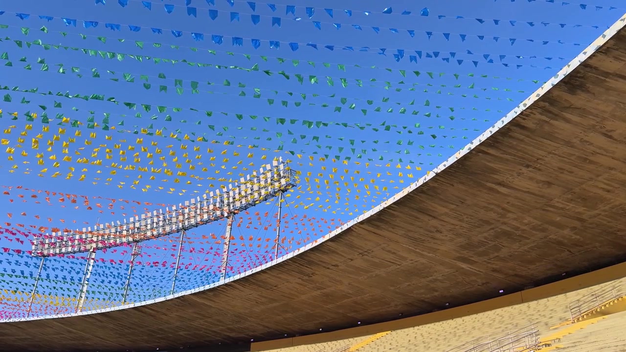 Colorful Bunting Flags Swaying Over an Empty Stadium