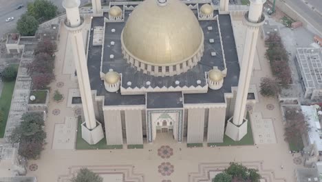 aerial jib reveal shot of a gold roofed palace-building