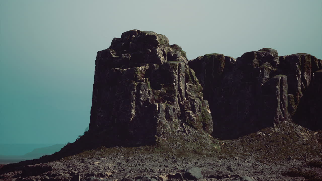 Rock formation stands tall against a muted sky in a remote landscape