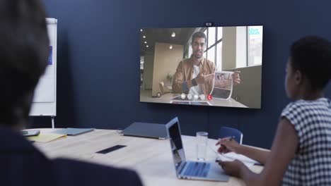 Diverse-business-people-on-video-call-with-african-american-male-colleague-on-screen