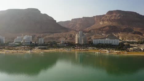 4k aerial drone dolly out rocky mountains near the dead sea hotel zone