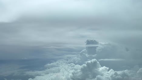 aerial view from a jet cockpit while flying near a huge cumulonimbus