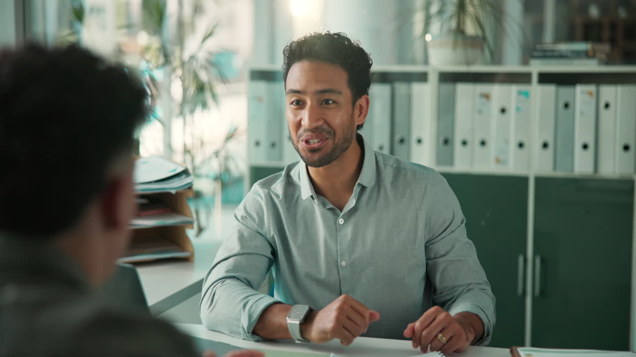 Smiling Businessman Shakes Hands with Colleague in Office