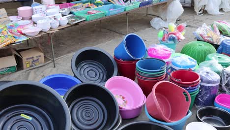 assorted plastic items displayed at an outdoor market