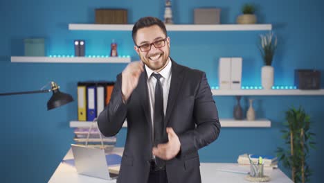 happy businessman clapping looking at camera.