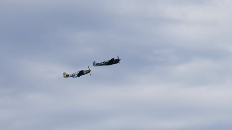 multiple helicopters maneuvering together in cloudy skies