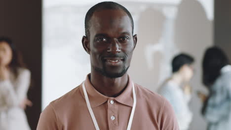 portrait of cheerful black man on business conference