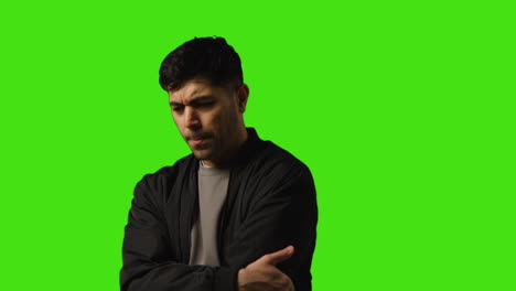 Portrait-Shot-Of-Worried-Or-Stressed-Looking-Man-Standing-Against-Studio-Green-Screen-Background