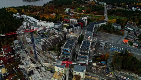 Approaching-aerial-over-construction-sites-in-Stockholm-area-of-Sweden-showing-tall-skyscrapers