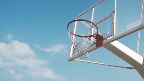 male basketball player runs up to hoop and scores in slow motion