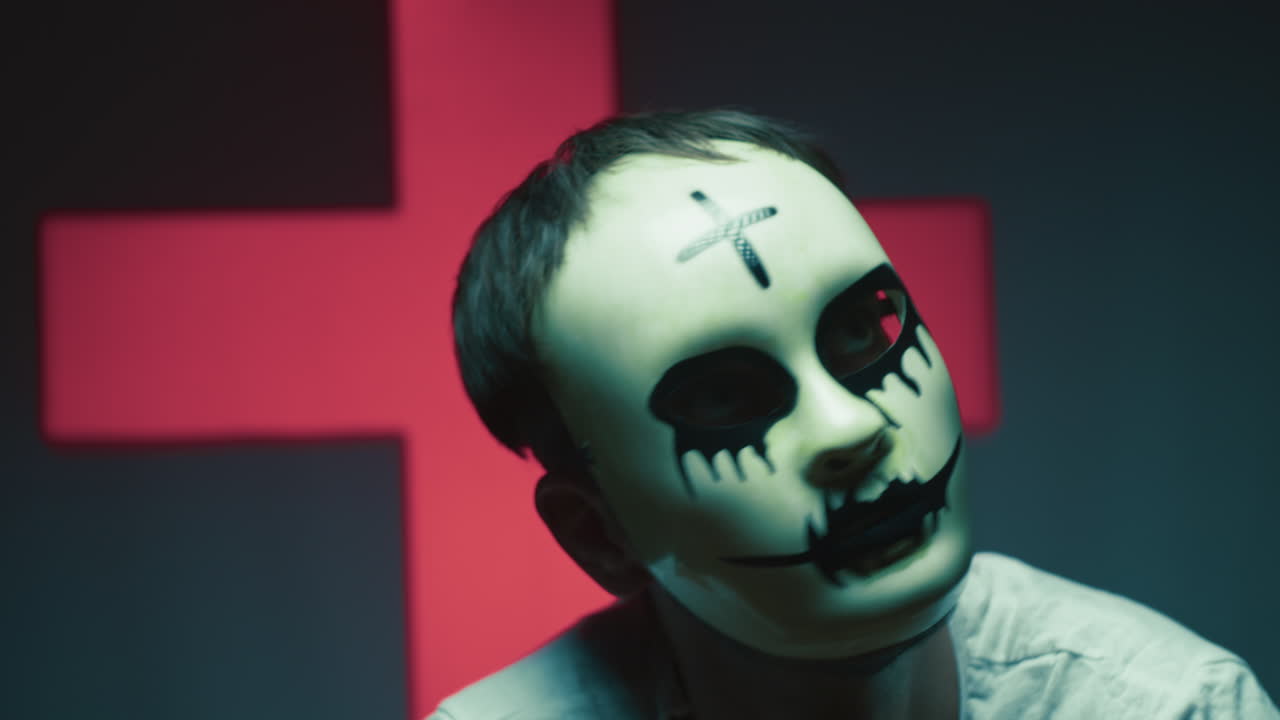 Stupid Monster Person Wearing Halloween Mask Steps on Book on Head