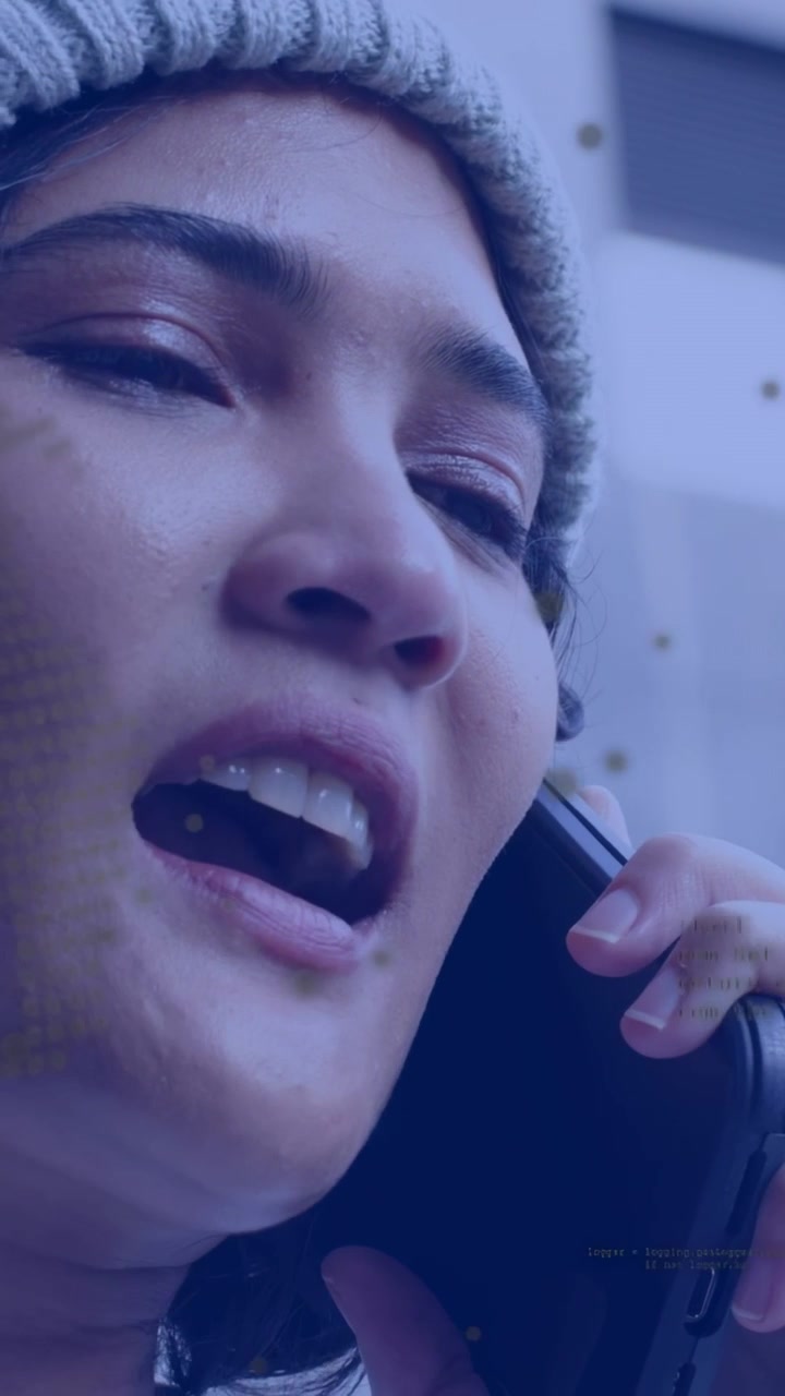 Vertical video: Woman bringing phone to ear and speaking outside, dotted HUD showing health data