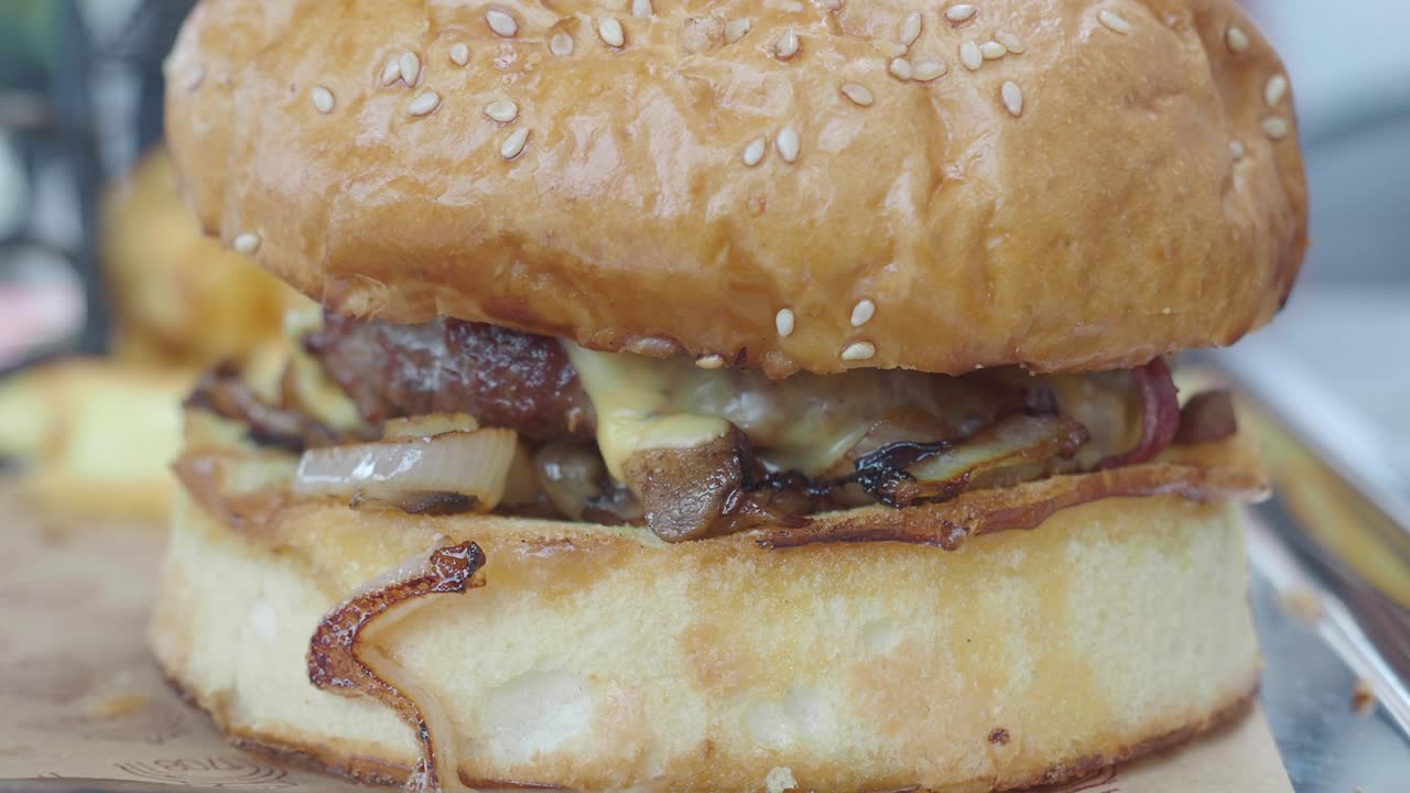 Close-up of a Gourmet Cheeseburger with Caramelized Onions and Melted Cheese