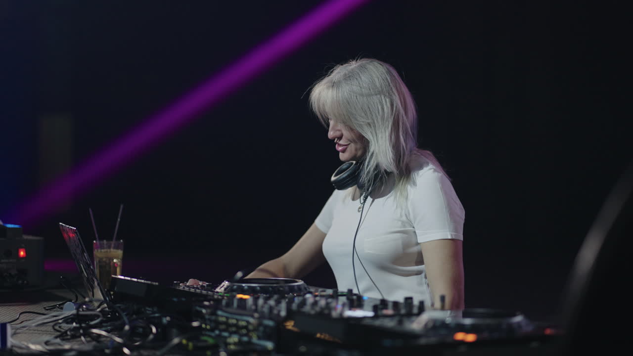 Female DJ performing at a nightclub