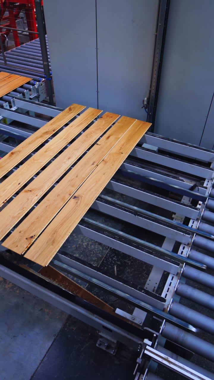 Process of making parquet boards indoors. Modern industrial factory for producing wooden laminate. Production of panels for flooring. Vertical video