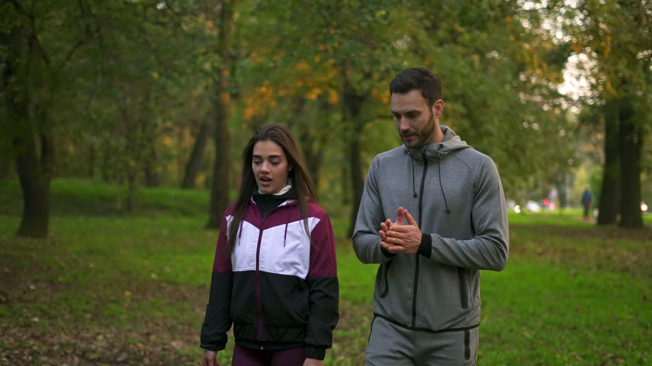 Couple Walking in the Park on an Autumn Day
