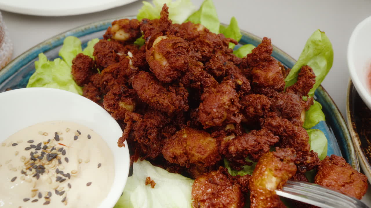 Crispy fried baby squids with creamy dipping sauce. Perfect for culinary and food shows.