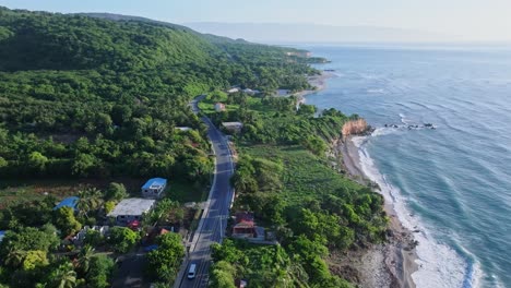 drone birds eye shot of tropical road near caribbean sea during sunny day on dominican republic island