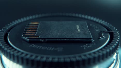 a macro close up shot of an sd memory card, black gold, on a 360 rotating stand, studio lighting, 120 fps slow motion, full hd