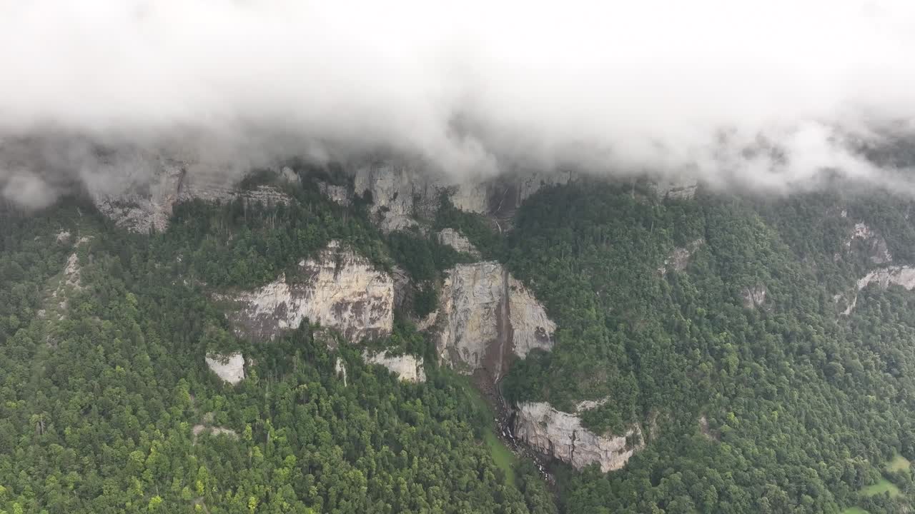 Mountain with waterfall and clouds