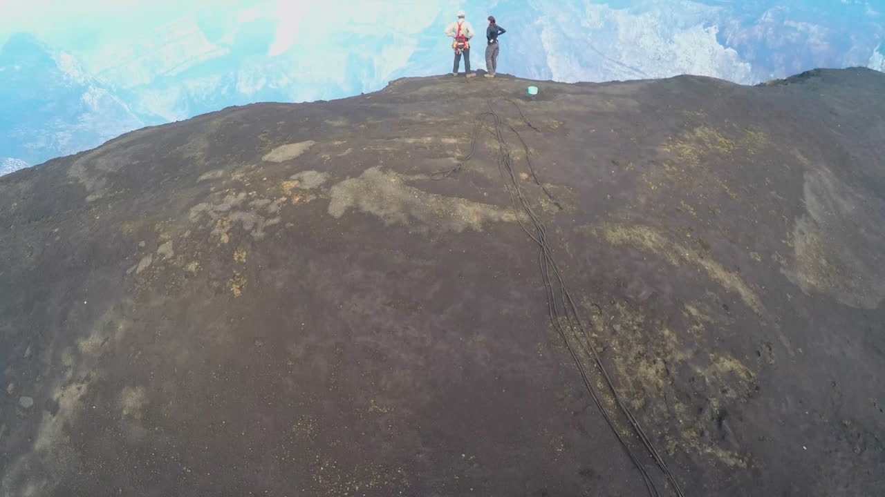 An excellent aerial over the Cape Verde volcano with two explorers watching