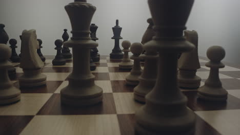 one person hand practices strategic tactical moves in chess game, low close up