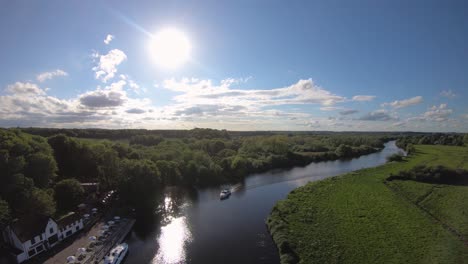 aerial drone footage of a boat sailing along the river yare, norfolk