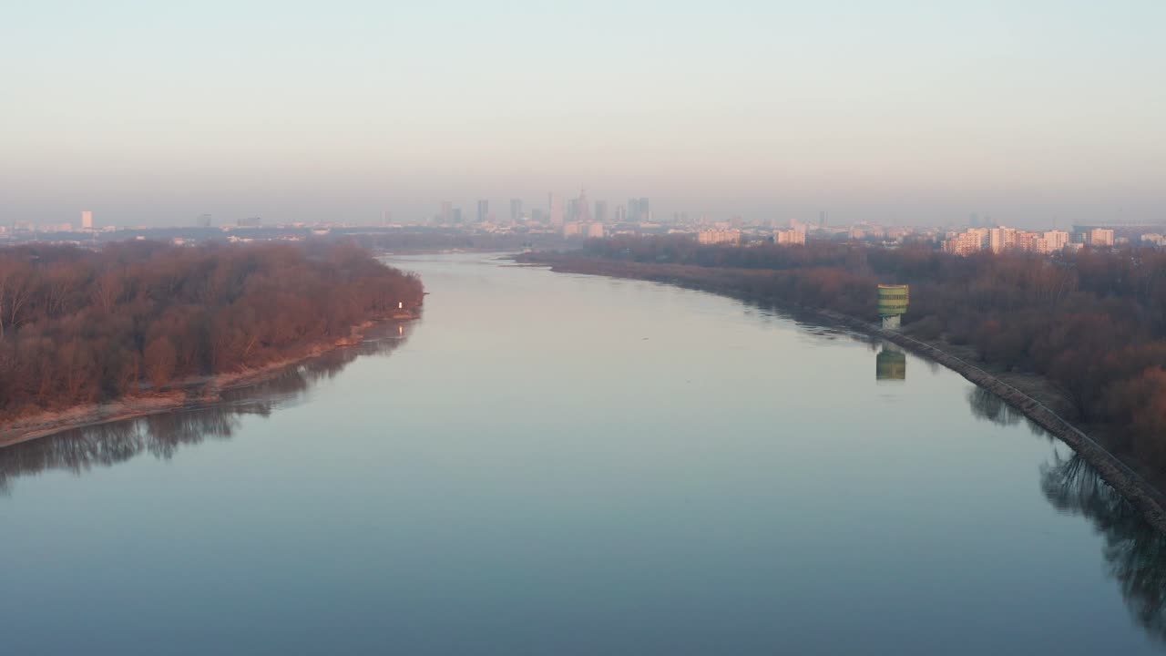 Flying over Vistula riwer. Warsaw during foggy morning