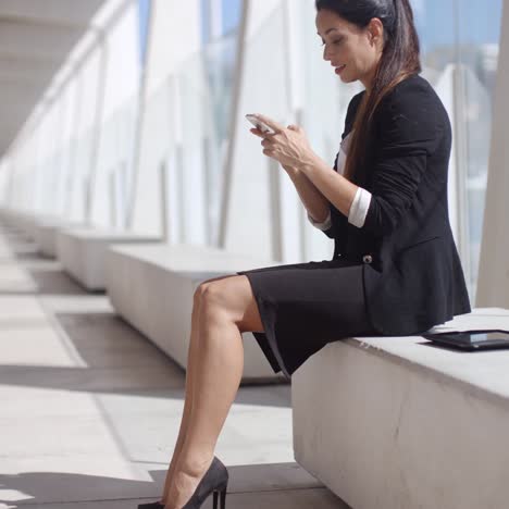 elegant businesswoman reading her text messages