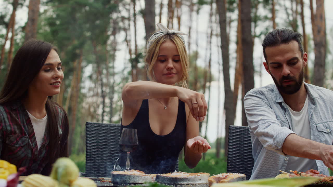 mujer añadiendo especias al pescado